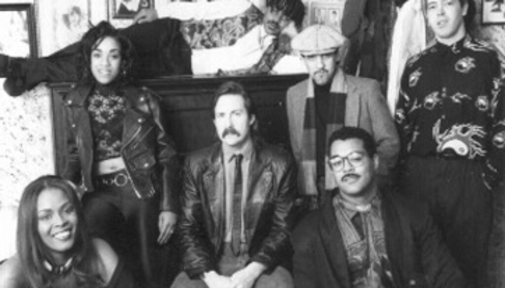 A group of people sitting in front of a couch.