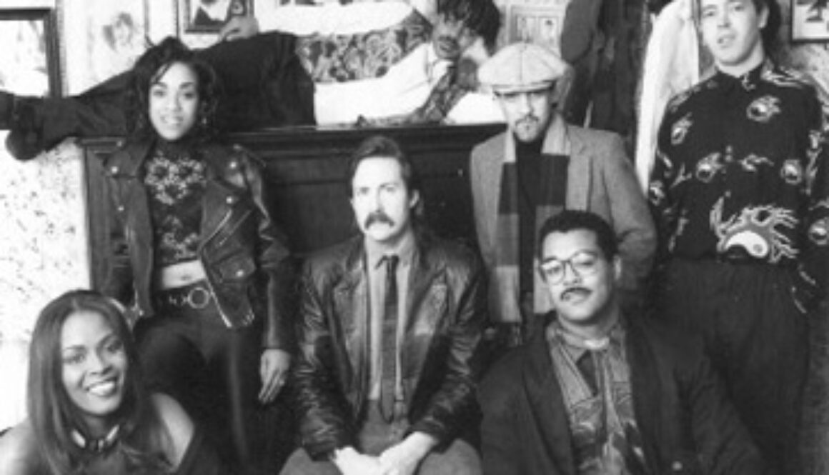 A group of people sitting in front of a couch.