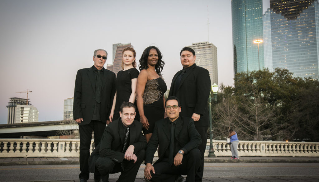 A group of people in black outfits posing for the camera.